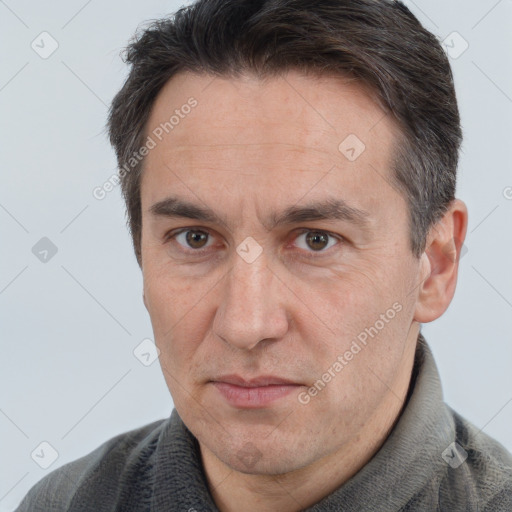 Joyful white adult male with short  brown hair and brown eyes