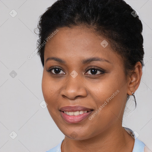 Joyful black young-adult female with short  brown hair and brown eyes