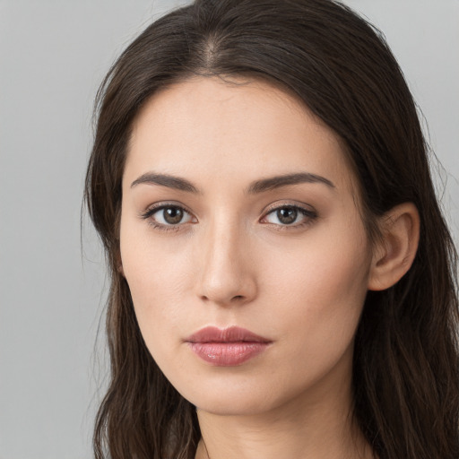 Neutral white young-adult female with long  brown hair and brown eyes