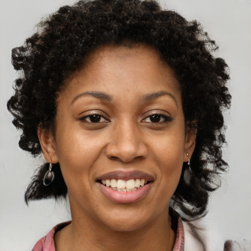Joyful black young-adult female with medium  brown hair and brown eyes