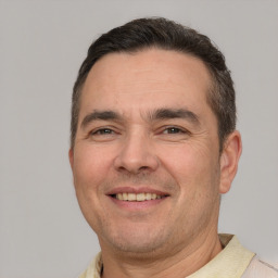 Joyful white adult male with short  brown hair and brown eyes