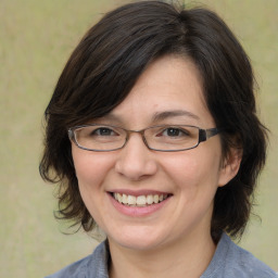 Joyful white adult female with medium  brown hair and brown eyes