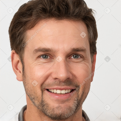 Joyful white adult male with short  brown hair and brown eyes