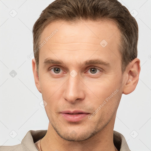 Joyful white young-adult male with short  brown hair and grey eyes