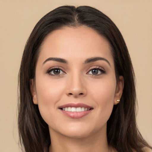 Joyful white young-adult female with long  brown hair and brown eyes