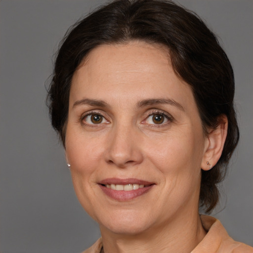 Joyful white adult female with medium  brown hair and brown eyes