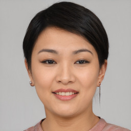 Joyful asian young-adult female with short  black hair and brown eyes