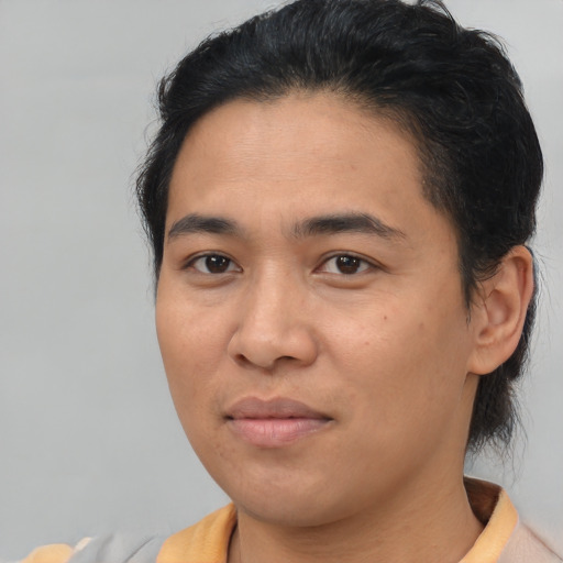 Joyful asian young-adult male with medium  brown hair and brown eyes