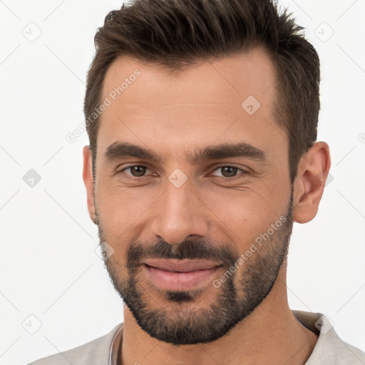 Joyful white young-adult male with short  brown hair and brown eyes