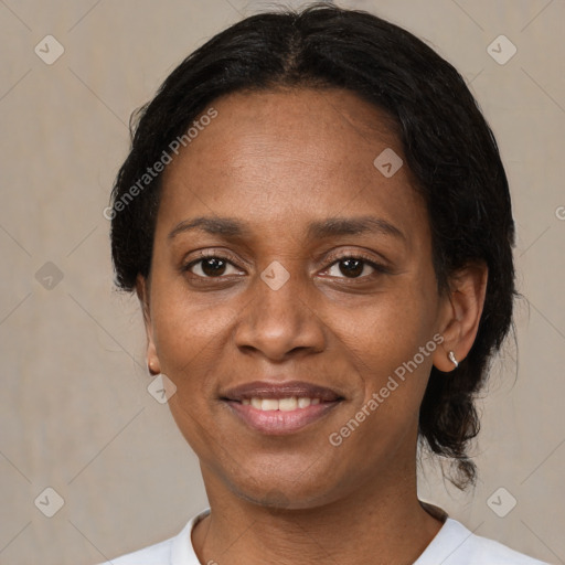 Joyful black adult female with medium  brown hair and brown eyes