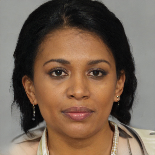 Joyful black young-adult female with medium  brown hair and brown eyes