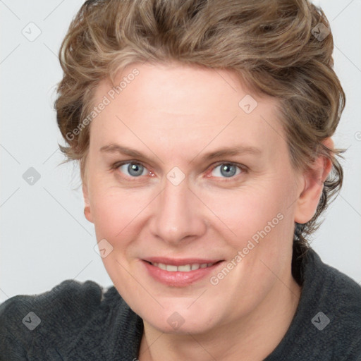 Joyful white adult female with medium  brown hair and blue eyes