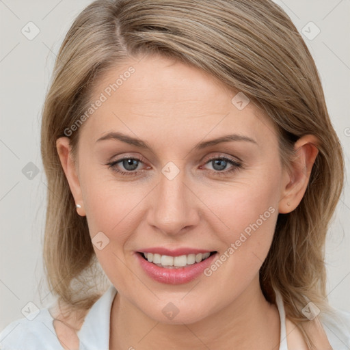 Joyful white young-adult female with medium  brown hair and blue eyes