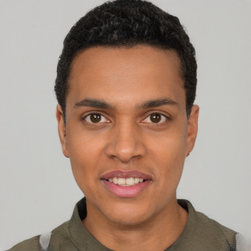Joyful latino young-adult male with short  black hair and brown eyes