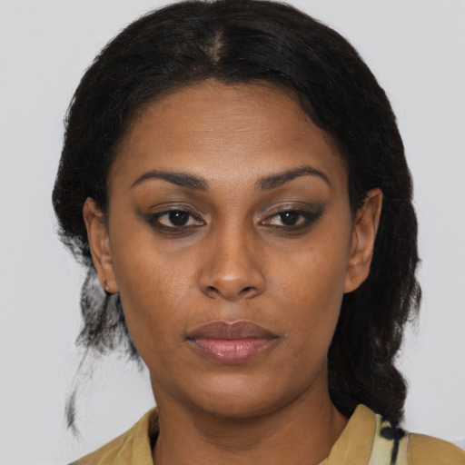 Neutral black young-adult female with medium  brown hair and brown eyes