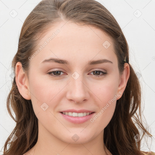 Joyful white young-adult female with long  brown hair and blue eyes