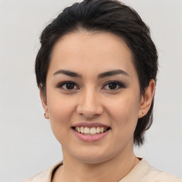 Joyful latino young-adult female with medium  brown hair and brown eyes