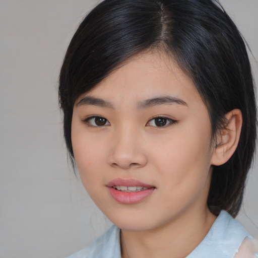 Joyful asian young-adult female with medium  black hair and brown eyes