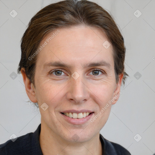 Joyful white adult male with short  brown hair and grey eyes