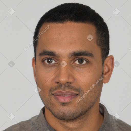 Joyful black young-adult male with short  black hair and brown eyes