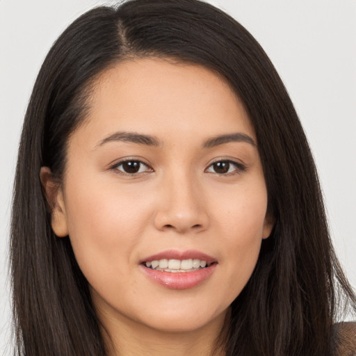 Joyful white young-adult female with long  brown hair and brown eyes