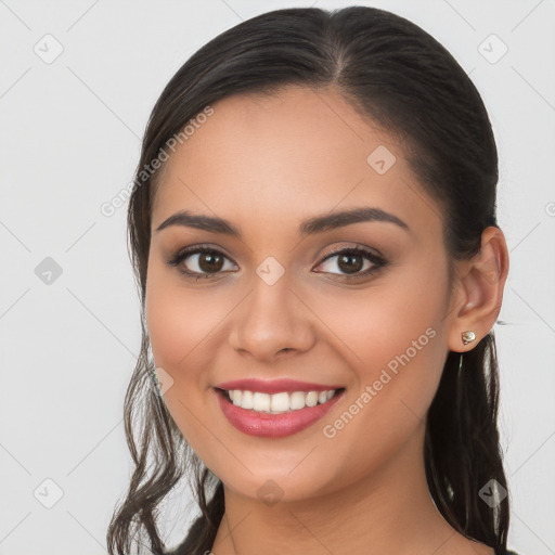 Joyful white young-adult female with long  brown hair and brown eyes