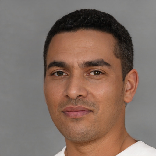 Neutral latino young-adult male with short  black hair and brown eyes