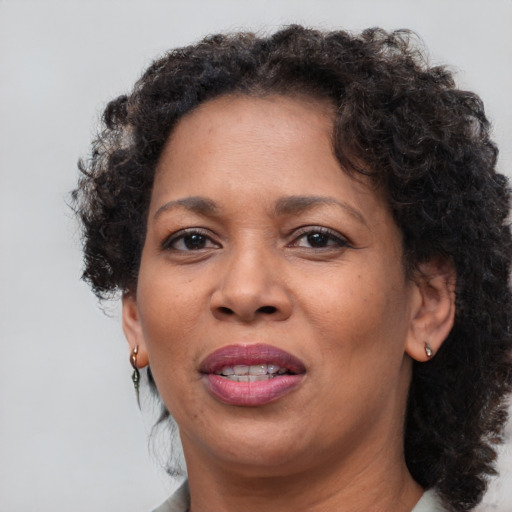 Joyful black adult female with short  brown hair and brown eyes