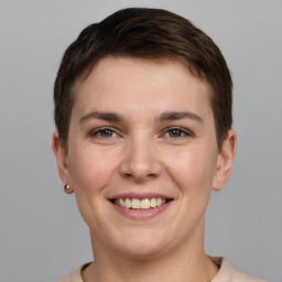 Joyful white young-adult female with short  brown hair and brown eyes