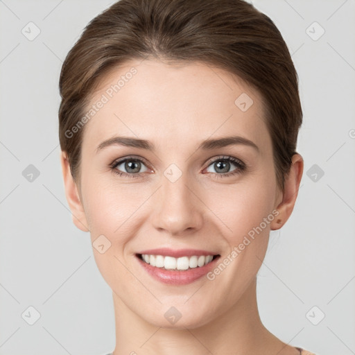 Joyful white young-adult female with short  brown hair and grey eyes