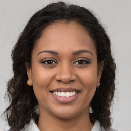 Joyful latino young-adult female with long  brown hair and brown eyes