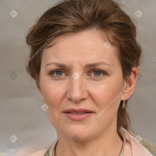 Joyful white adult female with medium  brown hair and blue eyes