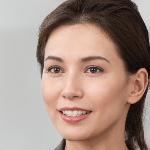 Joyful white young-adult female with medium  brown hair and brown eyes