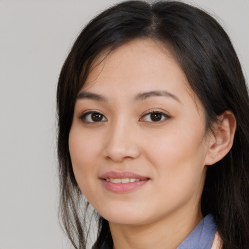 Joyful asian young-adult female with long  brown hair and brown eyes