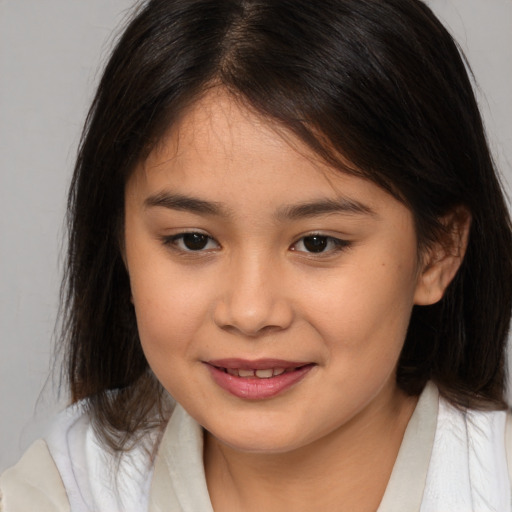 Joyful asian child female with medium  brown hair and brown eyes
