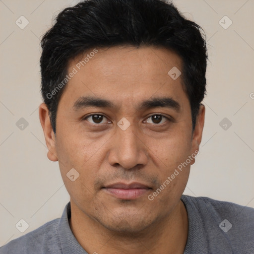 Joyful asian young-adult male with short  black hair and brown eyes