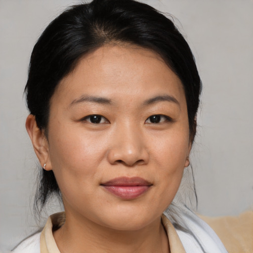 Joyful asian young-adult female with medium  brown hair and brown eyes