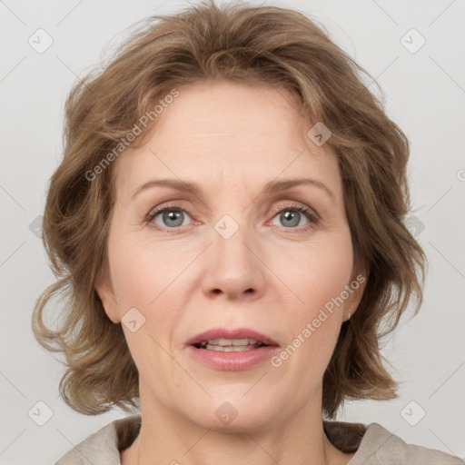 Joyful white adult female with medium  brown hair and blue eyes