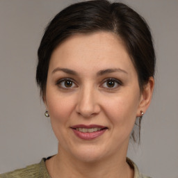 Joyful white adult female with medium  brown hair and brown eyes