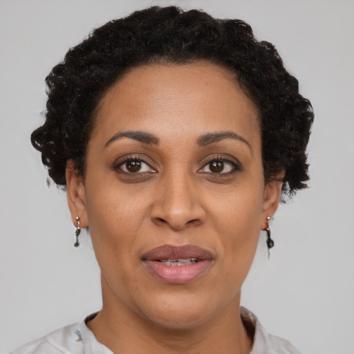 Joyful black adult female with short  brown hair and brown eyes