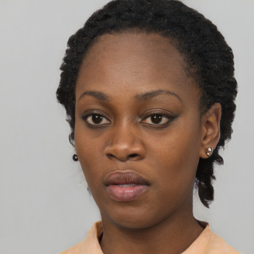 Neutral black young-adult female with medium  black hair and brown eyes