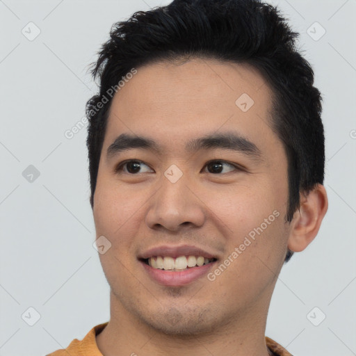 Joyful asian young-adult male with short  black hair and brown eyes