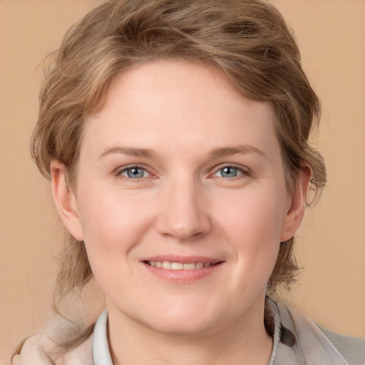 Joyful white young-adult female with medium  brown hair and blue eyes