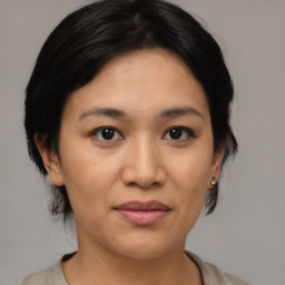 Joyful asian young-adult female with medium  black hair and brown eyes