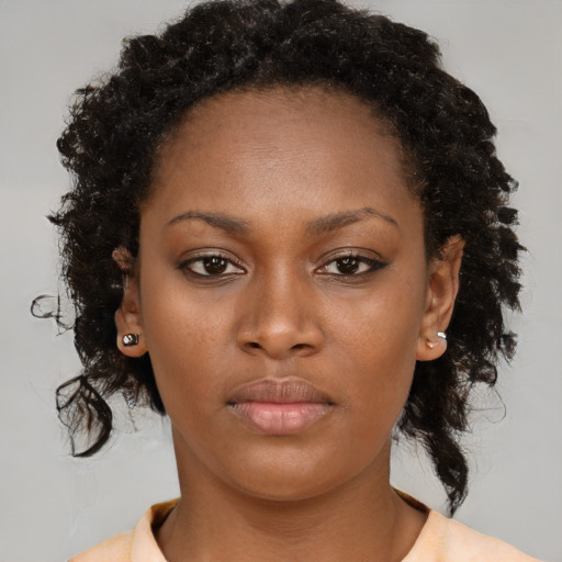 Neutral black young-adult female with medium  brown hair and brown eyes