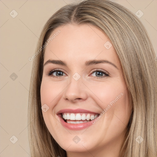 Joyful white young-adult female with long  brown hair and brown eyes