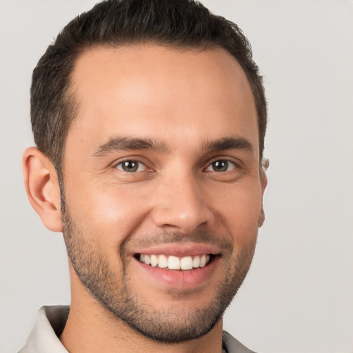 Joyful white young-adult male with short  brown hair and brown eyes