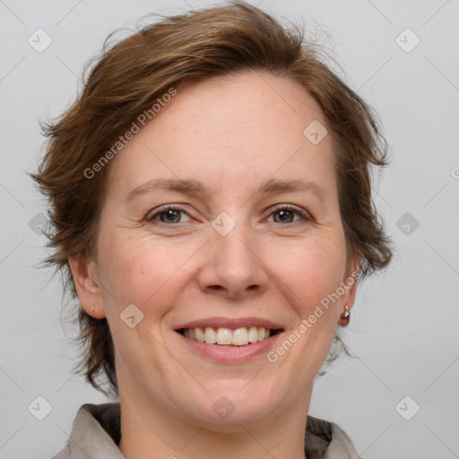 Joyful white adult female with medium  brown hair and blue eyes