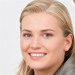 Joyful white young-adult female with long  brown hair and blue eyes