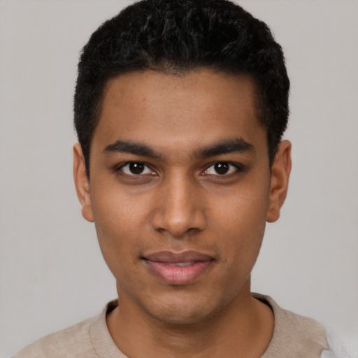 Joyful black young-adult male with short  black hair and brown eyes